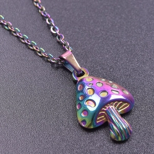 Macro shot of rainbow-colored mushroom pendant with textured details on a black surface