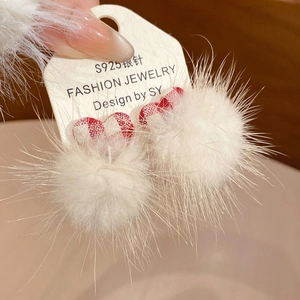 Close-up of S925 silver needle earrings featuring white fur balls and red plaid hearts