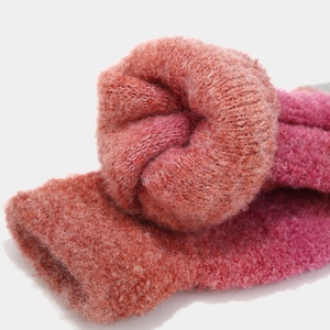 Close-up of thick gradient pink and orange knit texture with soft plush inner lining