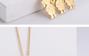 Detailed macro view of three gold-plated cartoon girl pendants with Love engraving