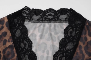 Close-up of leopard print mesh top featuring delicate black lace trim at the V-neckline