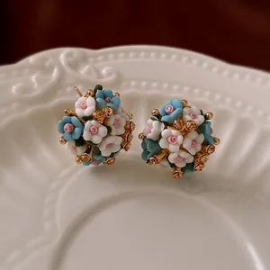 Elegant floral cluster earrings with colorful ceramic roses and rhinestones on gold base