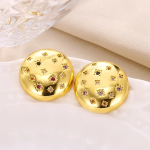 Detailed macro view of gold circular stud earrings inlaid with multicolored zircons