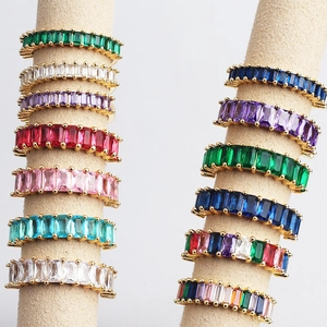 Detail view of colorful rectangular zircon row rings set in gold-plated bases on display