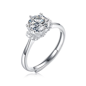 Macro detail of six-prong moissanite ring with side accent diamonds and adjustable band
