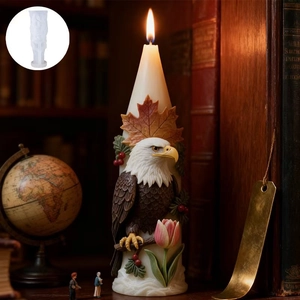 Macro detail of 3D eagle and maple leaf carvings on a tall conical scented candle
