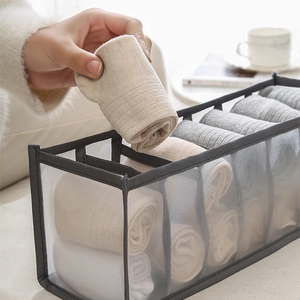 Grey mesh storage box with dividers for organized socks and underwear in drawers