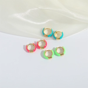 Three pairs of vintage gold plated enamel hoop earrings in blue, pink, and neon green colors
