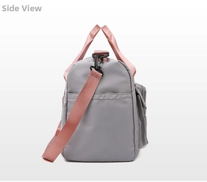 Side view of gray gym bag with pink straps and functional side storage pockets
