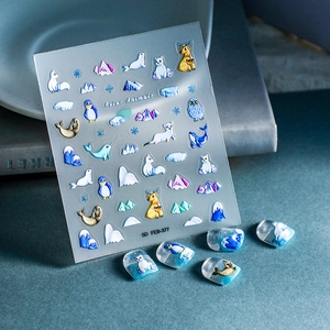 Detail of 5D embossed nail stickers featuring polar animals like penguins and polar bears