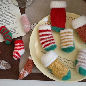 Close-up of assorted colorful mini knitted Christmas socks for holiday crafts and decor