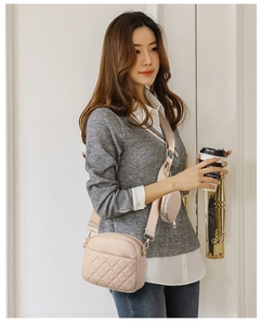 Beige quilted crossbody bag with wide strap and matching round coin pouch detail
