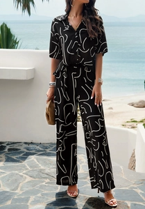 Detail of printed short sleeve shirt and wide leg pants set in a coastal resort setting