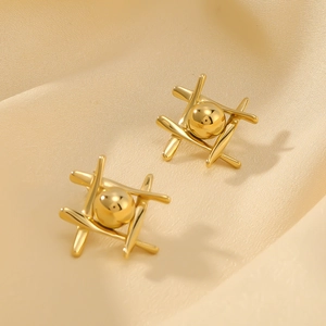 Minimalist gold stainless steel geometric stud earrings with spheres on silk background