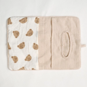 Close-up of cotton muslin baby crib organizer featuring cute bear prints and soft fabric