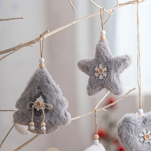 Plush Christmas ornaments with faux fur stars and hearts hanging on white branches