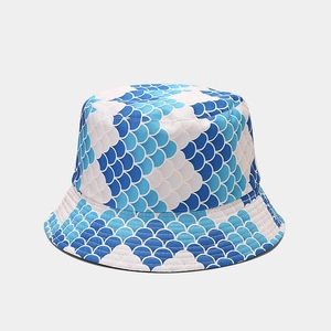 Detailed view of breathable blue fish scale pattern texture on reversible bucket hat