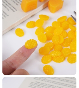Macro shot of 1.5cm miniature yellow resin mango cubes with realistic grid texture