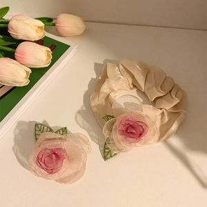 Elegant dried rose organza hair clip and scrunchie set on minimalist background