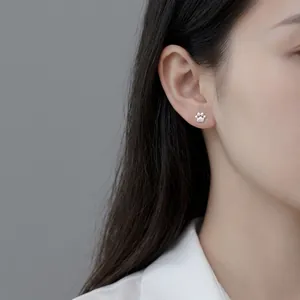 Minimalist S925 sterling silver cute cat paw hook earrings worn on a female ear