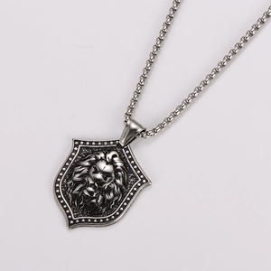 Detailed view of silver stainless steel lion head shield pendant with box chain necklace