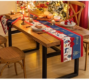 Close-up of a festive Christmas table runner with reindeer and Merry Christmas print