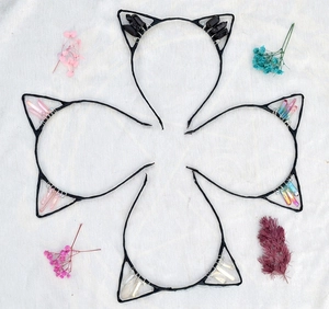 Detail view of four handmade cat ear headbands with colorful raw crystal quartz stones