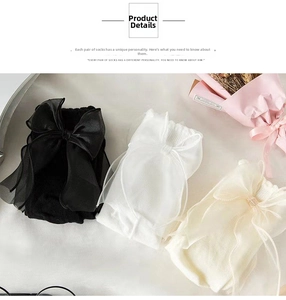 Close-up of elegant mid-calf socks with large organza bow details in black and white