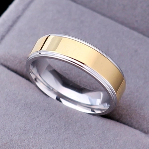 Close-up of a two-tone silver and gold stainless steel ring inside a gray jewelry box