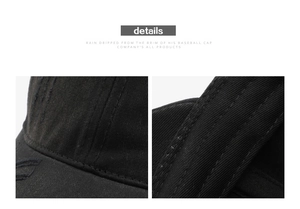Detail view of distressed black baseball cap with vintage frayed edges and stitched brim