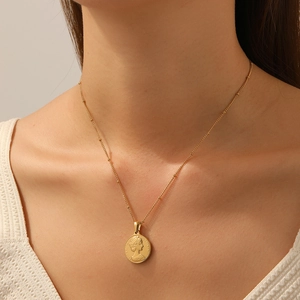 Vintage gold-plated stainless steel coin necklace featuring a portrait pendant on a bead chain