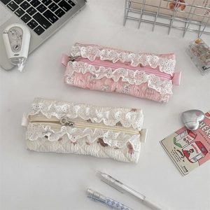 Detail of quilted lace pencil cases in pink and cream with sweet cartoon animal patterns