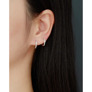 Close-up of elegant S925 sterling silver hoop earrings with sparkling zircon on earlobe