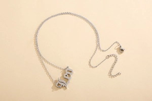 Macro shot of silver Leo zodiac pendant necklace with a polished vintage letter charm