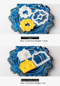 Detailed Christmas wreath and house cookie molds with dimensions on a blue plate