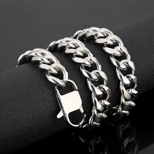 Close-up of 15mm silver cuban link chain with large lobster clasp on black pedestal