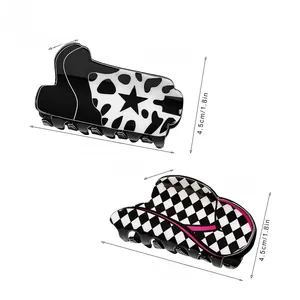 Detailed size view of black and white cow print and checkerboard hair claw clips