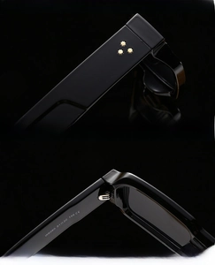 Macro detail of black square sunglasses with golden rivets and hinge specifications