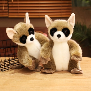 Soft plush lemur doll set with big eyes and fluffy fur on a warm wooden table