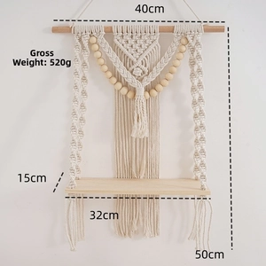 Detail view of woven cotton rope shelf with wood beads and dimensions 40x50 cm
