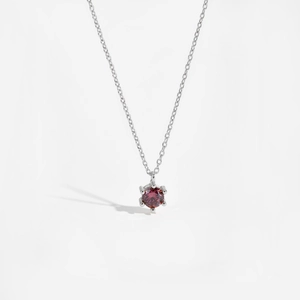 Detailed view of s925 silver necklace featuring a red round zircon in six-prong setting