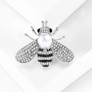 Detailed view of bee brooch featuring white pearls and shimmering crystal rhinestones
