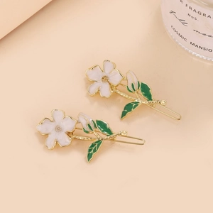 Elegant white enamel flower hair clips with green leaves and gold metal finish
