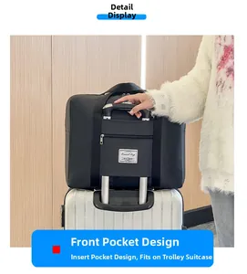 Detail of black travel bag with back sleeve sliding over a trolley luggage handle