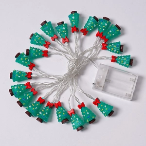 Detail of Christmas tree LED string lights with green trees and red bows decoration