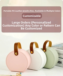 Detail view of portable leather jewelry boxes in pink, white and mint green