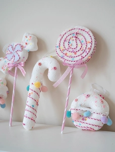 Pink and white Christmas candy ornaments including lollipop and donut with ribbons