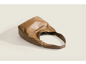 Detail of soft brown leather tote bag with wide shoulder strap for women daily commute