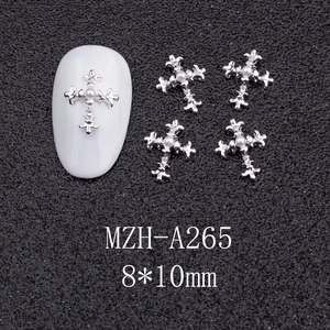 Detail of silver alloy cross nail charms with white pearl inlay for punk style DIY manicure