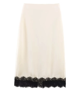 Detail of cream satin midi skirt featuring delicate black lace trim at the hemline